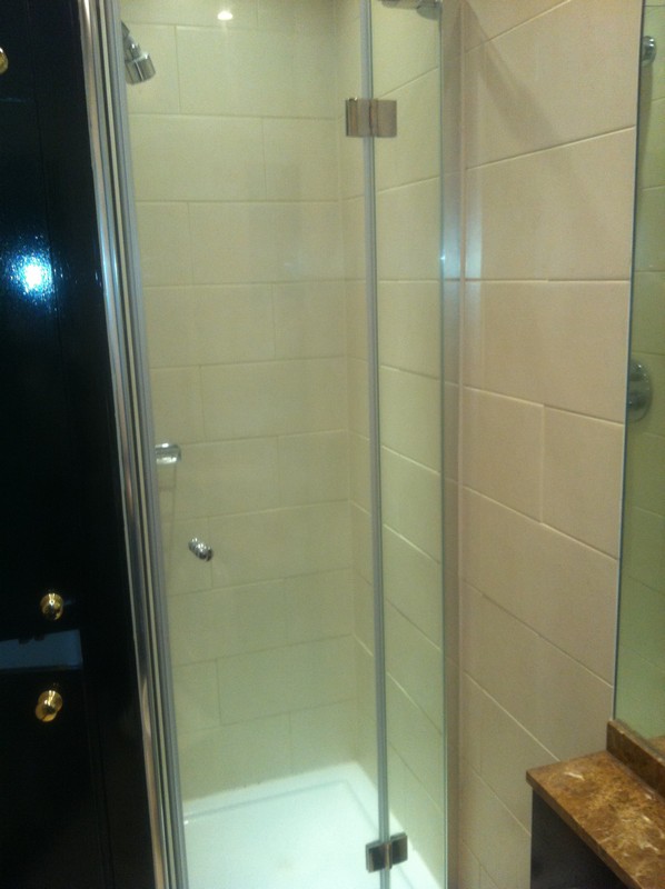 Frameless glass shower enclosure with chrome fittings in Fulham