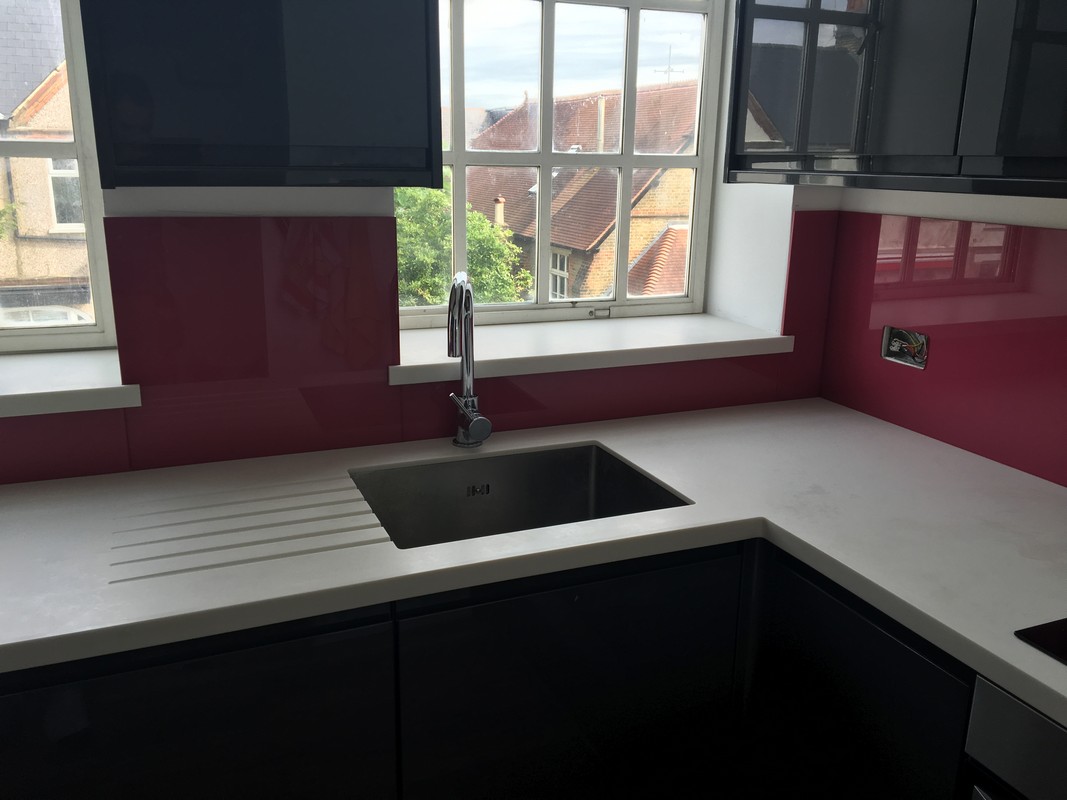 Deep plum coloured glass splashback in modern Fulham kitchen