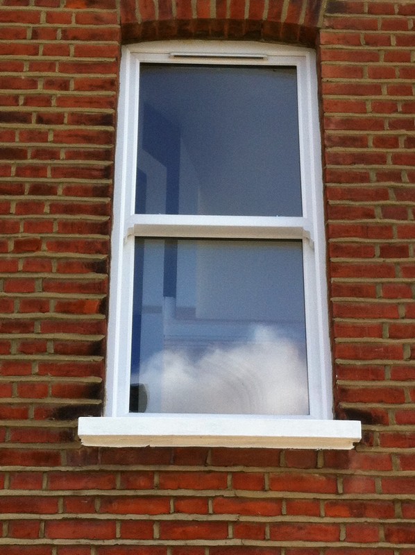 uPVC sash window on Victorian red brick house in Fulham